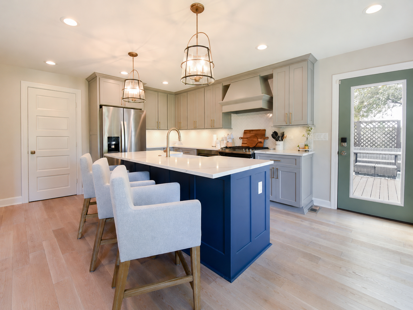 Open-concept kitchen remodel with navy island in Bloomingdale, Illinois by A.M. Woodland