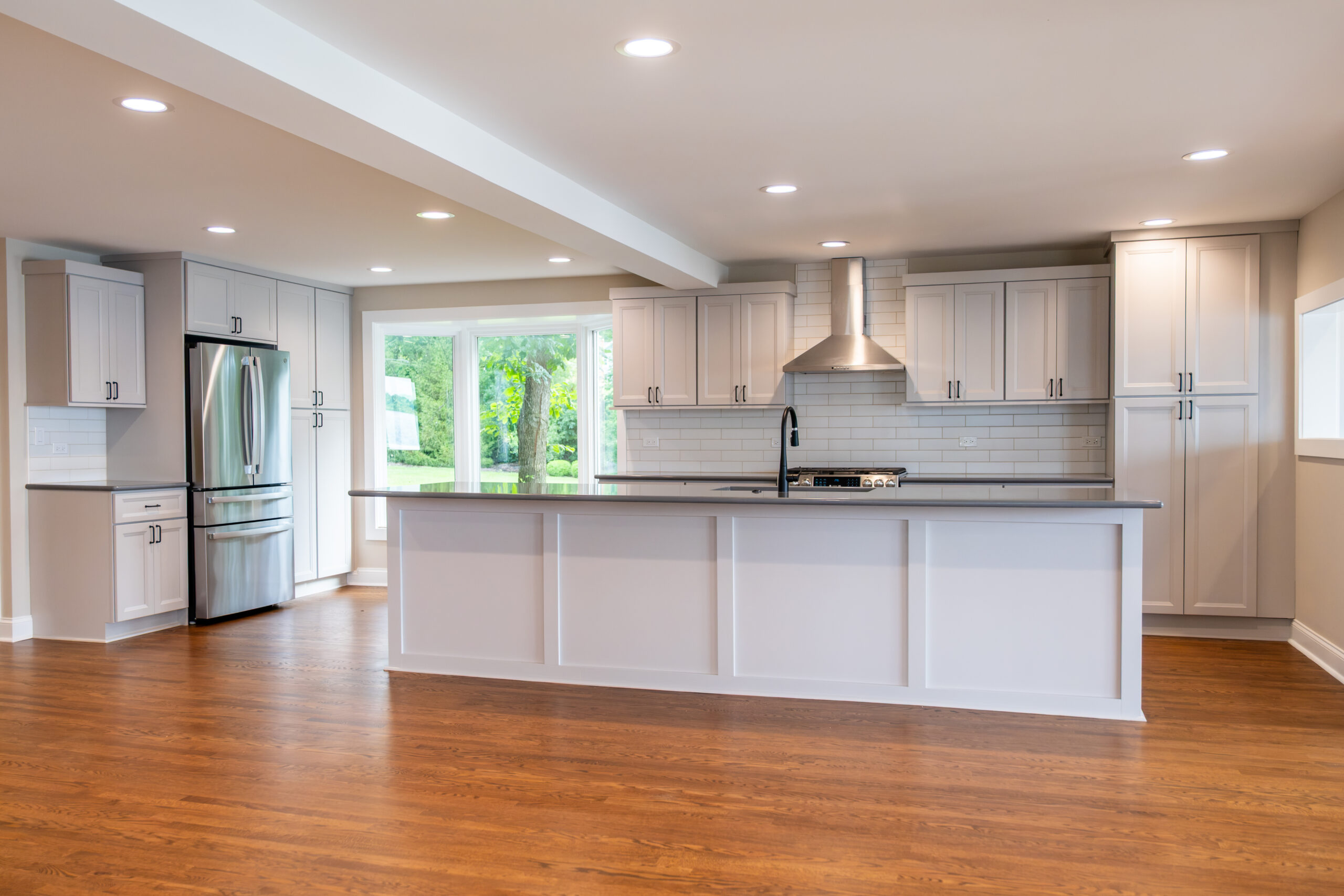 Classic kitchen remodel with quartz island and natural light in Ingleside, Illinois by A.M. Woodland